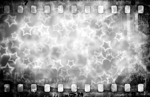Grunge scratched colorful film strip with stars background - Photo, Image