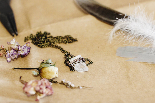 crystal necklace, feather, and dried flowers  - Photo, Image