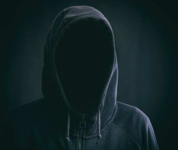 Hooded man on black background - Foto, Bild