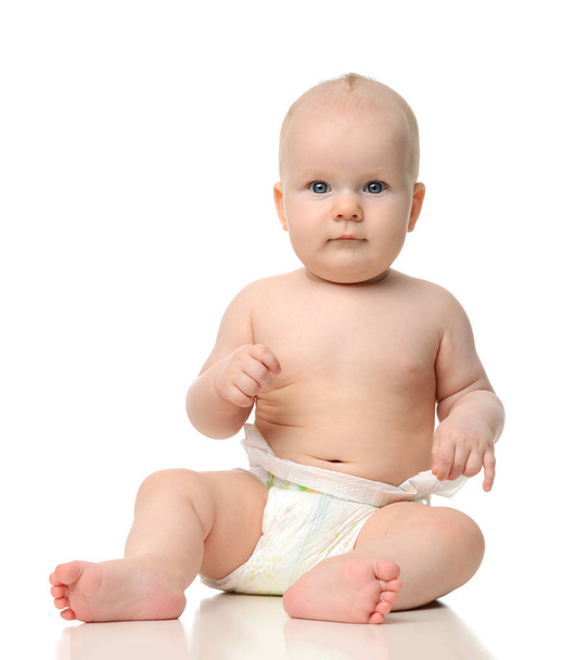 Infant child baby girl toddler sitting naked in diaper looking a - Photo, Image