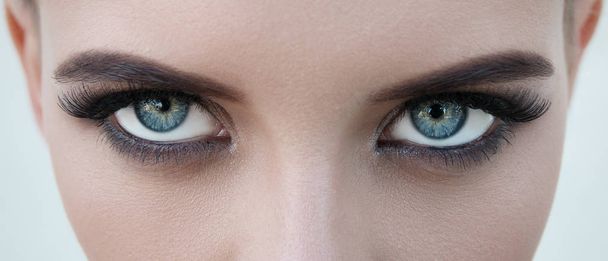 close-up face of pretty girl with beautiful big blue eyes, big eyelashes and eyebrows - Photo, Image