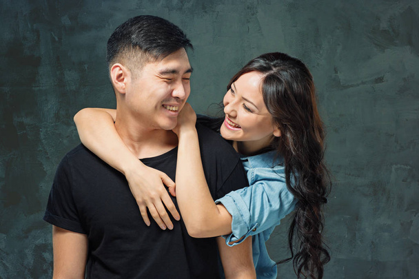 Portrait of smiling Korean couple on a gray - Zdjęcie, obraz