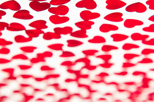 Valentines day pattern of red hearts confetti with blur on white background.  - Fotografie, Obrázek