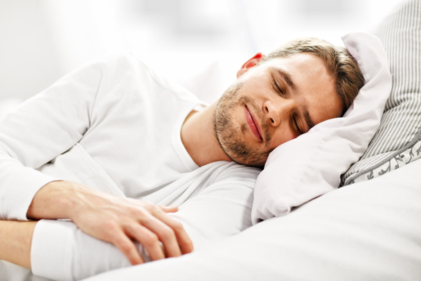 junger Mann schläft im Bett - Foto, Bild