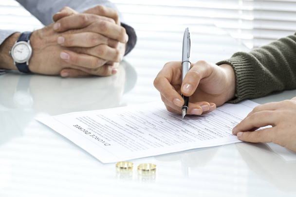 Esposa firma divorcio decreto formulario con anillo
 - Foto, imagen
