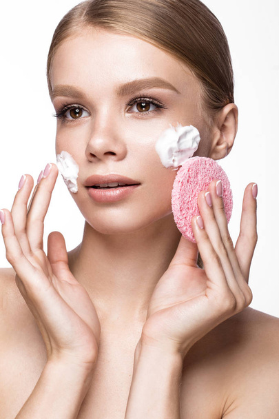 Beautiful young girl with sponge and foam cleanser, French manicure. Beauty face. - Фото, изображение
