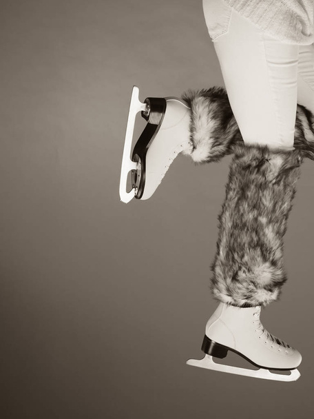 Woman legs wearing ice skates fur socks, skating  - Foto, Imagem