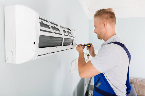 Technician Fixing Air Conditioner - Фото, изображение
