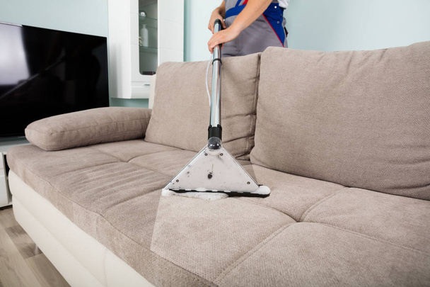 Man Cleaning Sofa - Фото, зображення