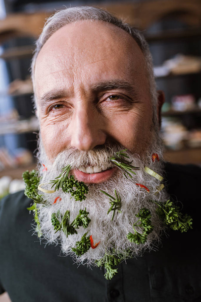 Senior man with greens in beard - Photo, Image