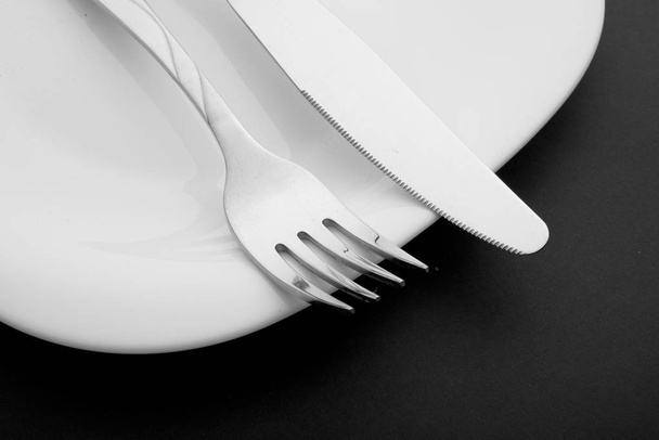 knife, fork and plate on a white background - Photo, image