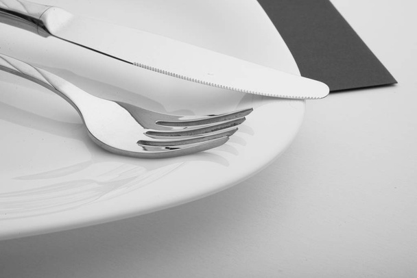 knife, fork and plate on a white background - Foto, Bild