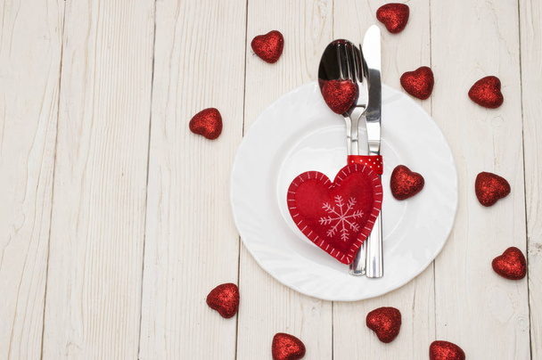 Table set for celebration Valentines Day. Wooden place setting with red heart . - 写真・画像