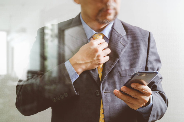 success businessman holding tie and using smart phone,thinking,f - Fotografie, Obrázek