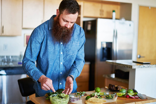 guy with beard tasting guacamole - Foto, Imagem