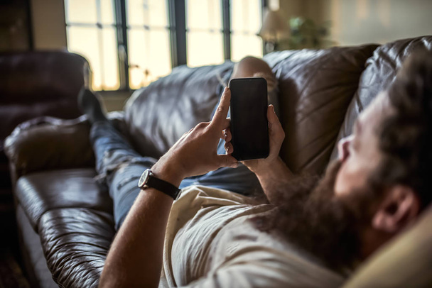 bearded guy using smart phone - Foto, imagen