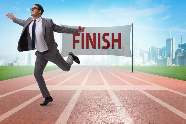 Businessman on the finishing line in competition concept - Foto, Imagem