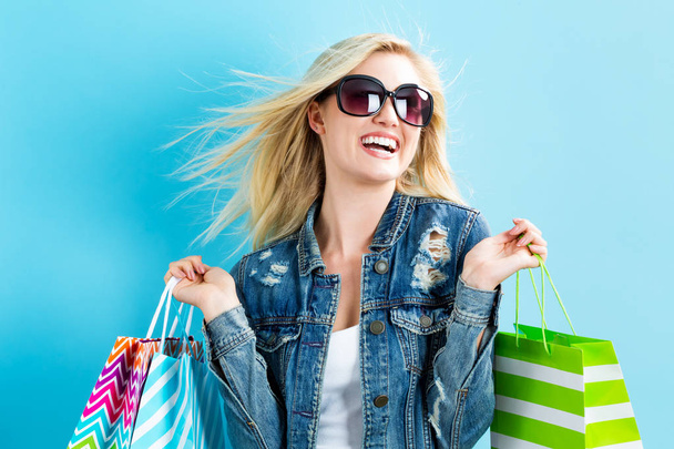 Happy young woman holding shopping bags - Фото, изображение