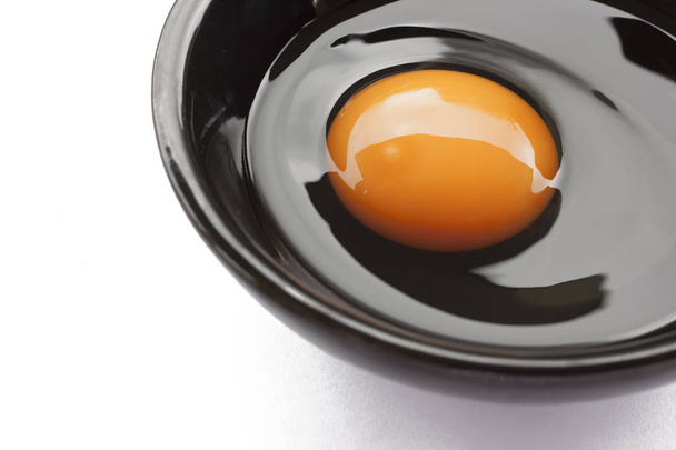 Eggs cooking for breakfast, a protein form yolk and albumen on a white background, or on a plain wooden table. - Фото, зображення