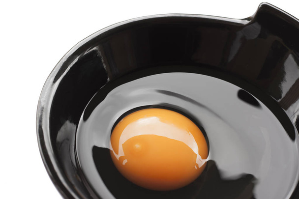 Eggs cooking for breakfast, a protein form yolk and albumen on a white background, or on a plain wooden table. - Fotografie, Obrázek
