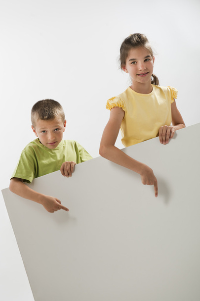 Two children holding a blank sign - Φωτογραφία, εικόνα