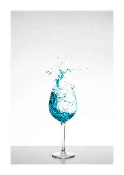 blue turquoise wine splash in the glass - Liquid art water drops splashes - Photo, Image