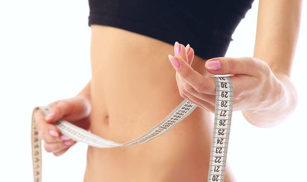 woman measure her waist belly by metre-stick - Foto, Imagem