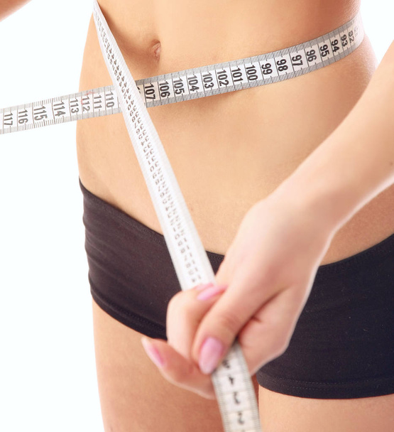 mujer medir su cintura vientre por metro-palo
 - Foto, imagen