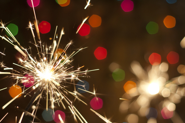 Sparkler e colorido bokeh natal fundo do ano novo
 - Foto, Imagem