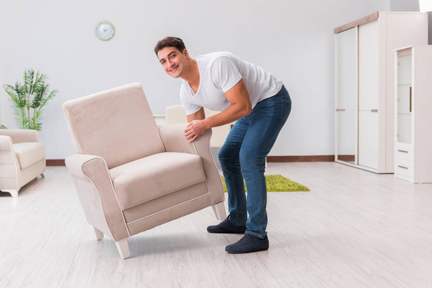Man moving furniture at home - Foto, immagini