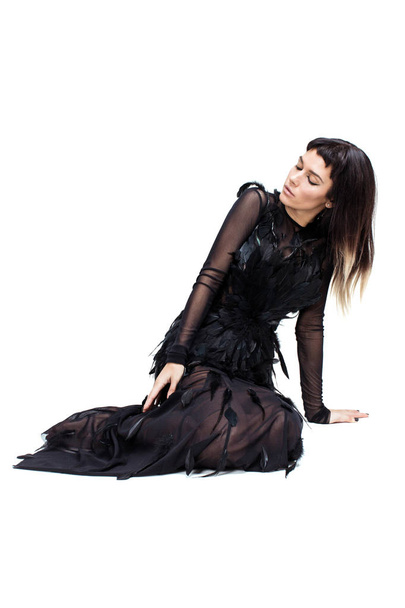 Elegant woman sitting on a floor and looking down - Fotografie, Obrázek