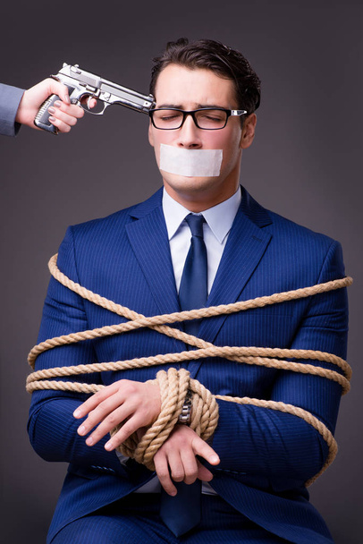 Businessman taken hostage and tied up with rope - Photo, Image