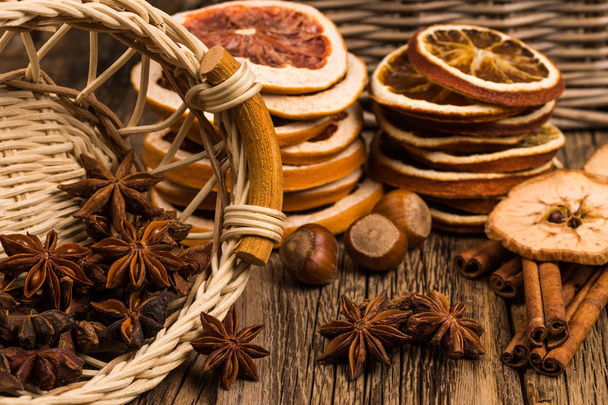Star anise in a wicker basket on an old wooden table.  - 写真・画像