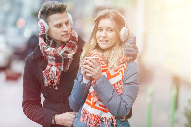 Young beautiful couple having fun in the winter on the street. Couple in love on Valentine's Day - Foto, Bild