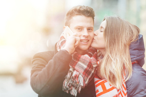 Young beautiful couple having fun in the winter on the street. Couple in love on Valentine's Day - Foto, immagini