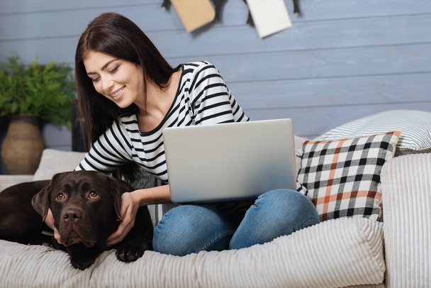 Relaxed pleased woman enjoying leisure time with her pet - Photo, image