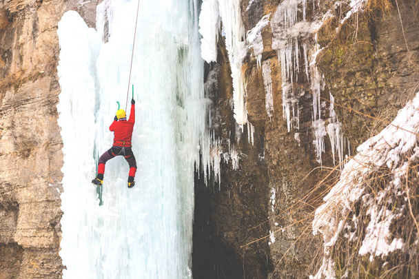 The climber climbs on ice. - Photo, image
