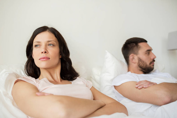 unhappy couple having conflict in bed at home - Foto, Imagen