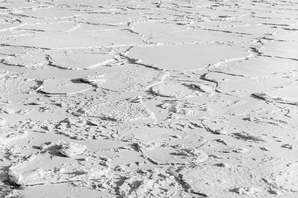 Frozen ice beneath in white snow - Фото, изображение