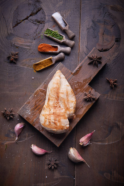 Grilled chicken breast, food background, wood background. - Zdjęcie, obraz