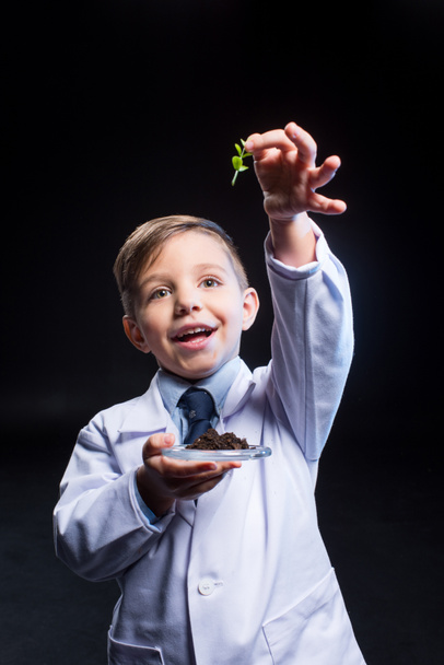 Little boy holding plant - Photo, Image