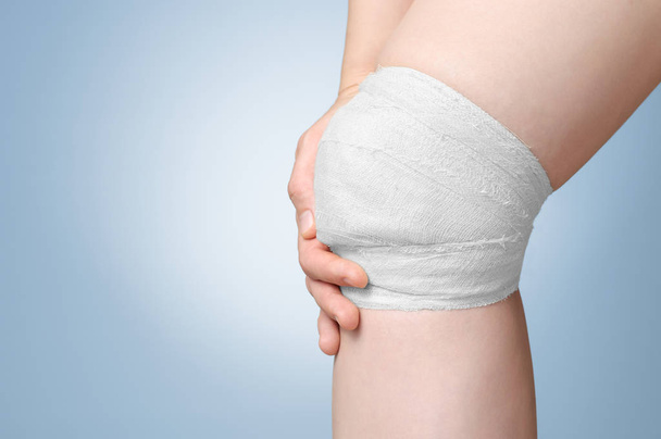 Injured knee with bandage - Foto, afbeelding