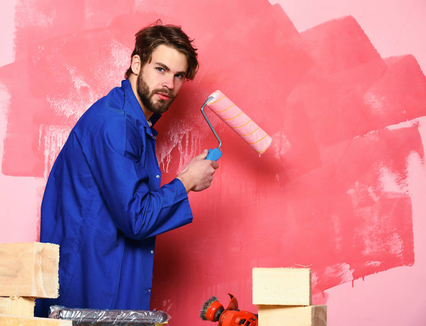 builder man holding paint roller - Foto, imagen