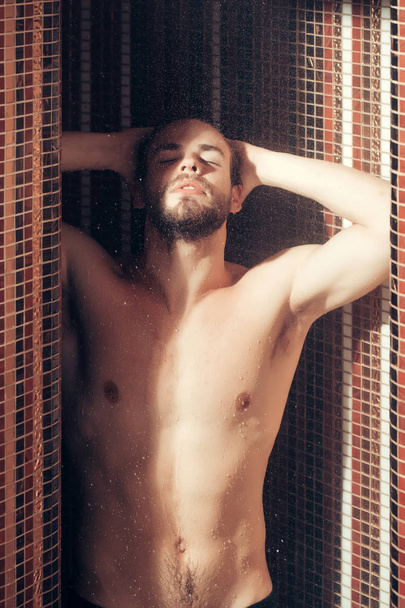 muscular handsome wet man in shower under water - Foto, immagini