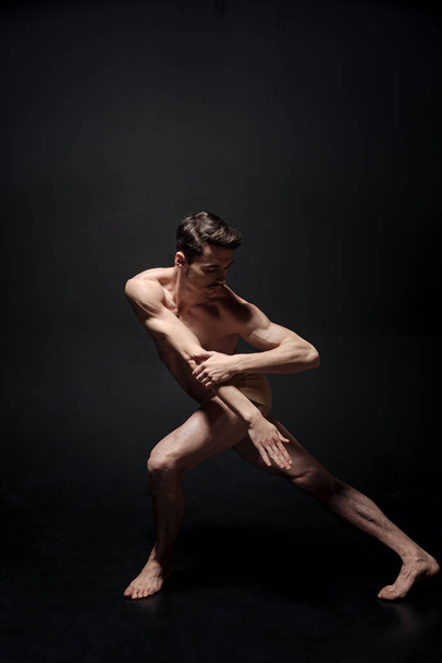 Skilled young dancer stretching  - Foto, Bild