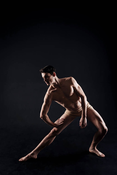 Involved young athlete stretching  - Fotó, kép