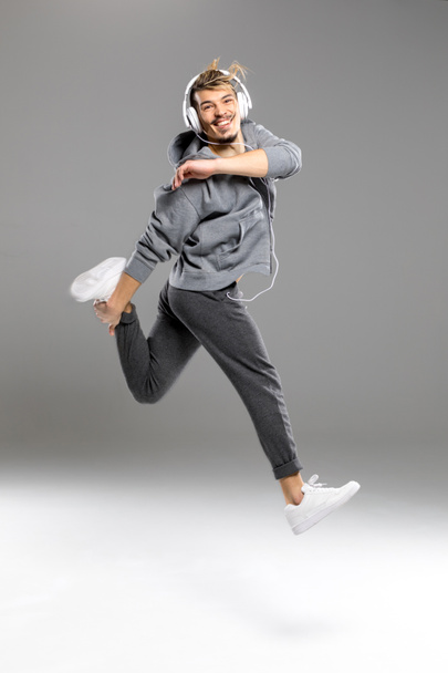 Man in headphones jumping - Photo, Image
