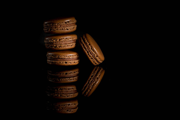 Sweet and colorful french macaroon or macaron on black background - Valokuva, kuva