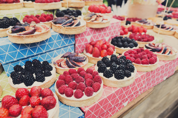 Fruit and berry tarts dessert tray assorted outdoors - Photo, Image