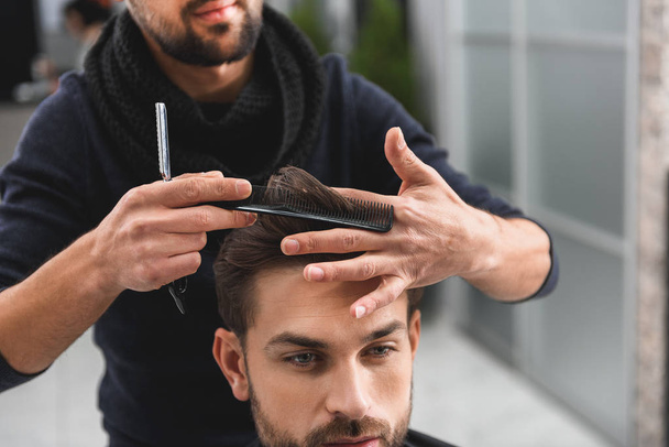 Professional hairdresser doing haircut for man - Φωτογραφία, εικόνα
